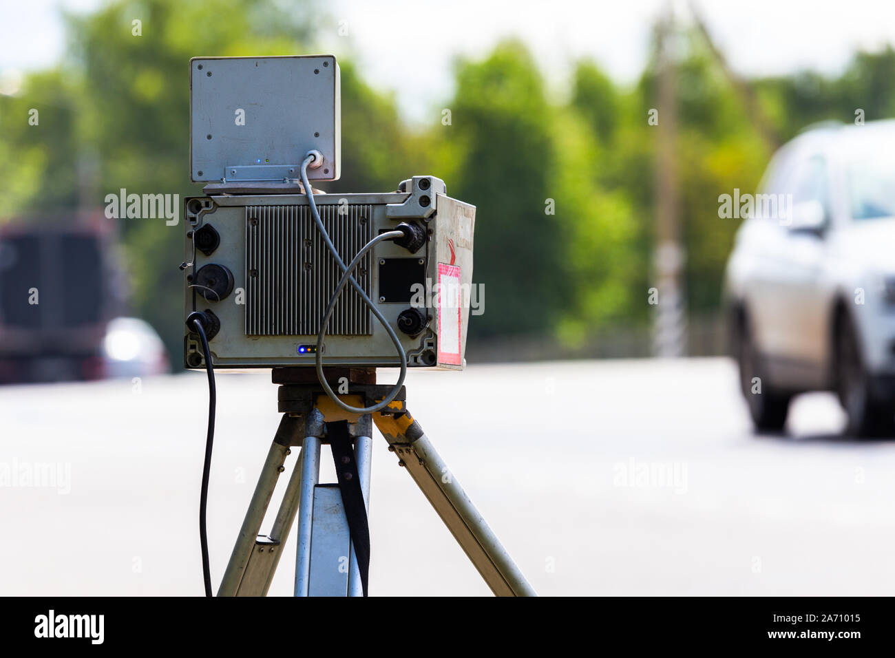 mobile speed camera device working on summer daytime road with selective focus back side Stock