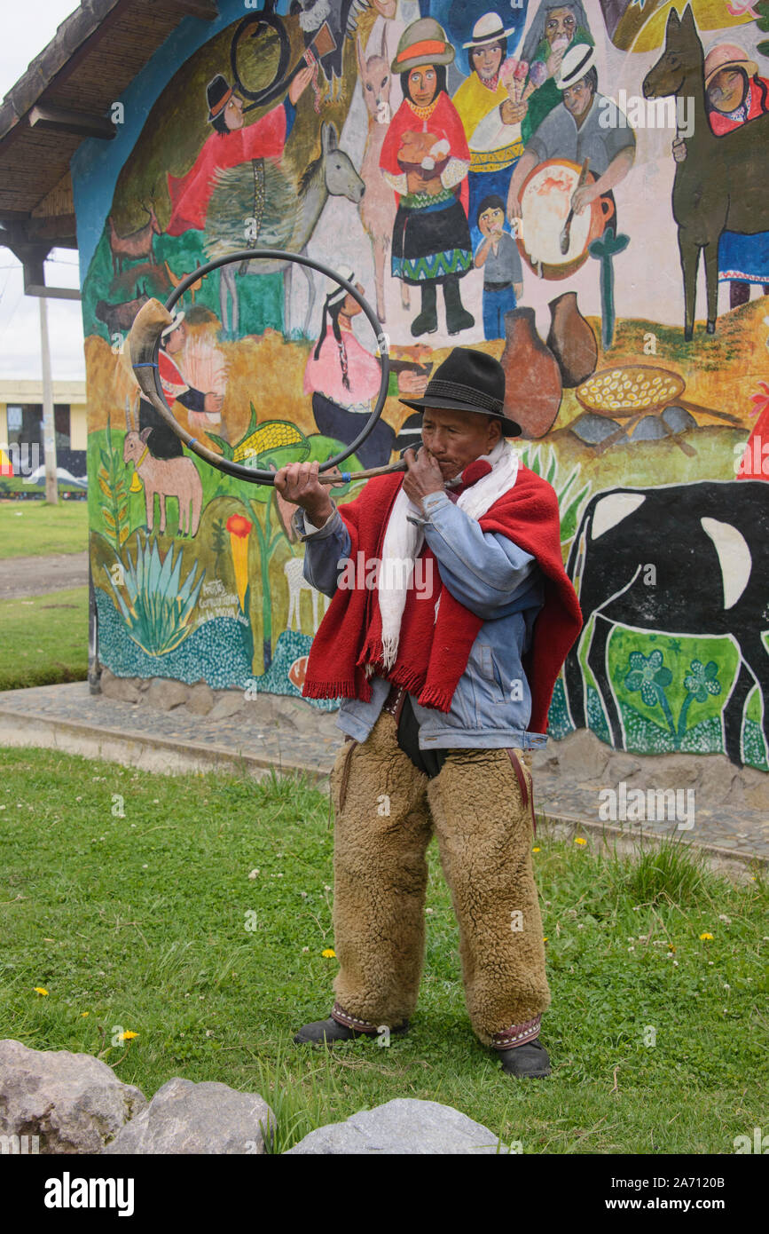 Indigenous highlander playing a cow horn trumpet, La Moya, Ecuador Stock Photo