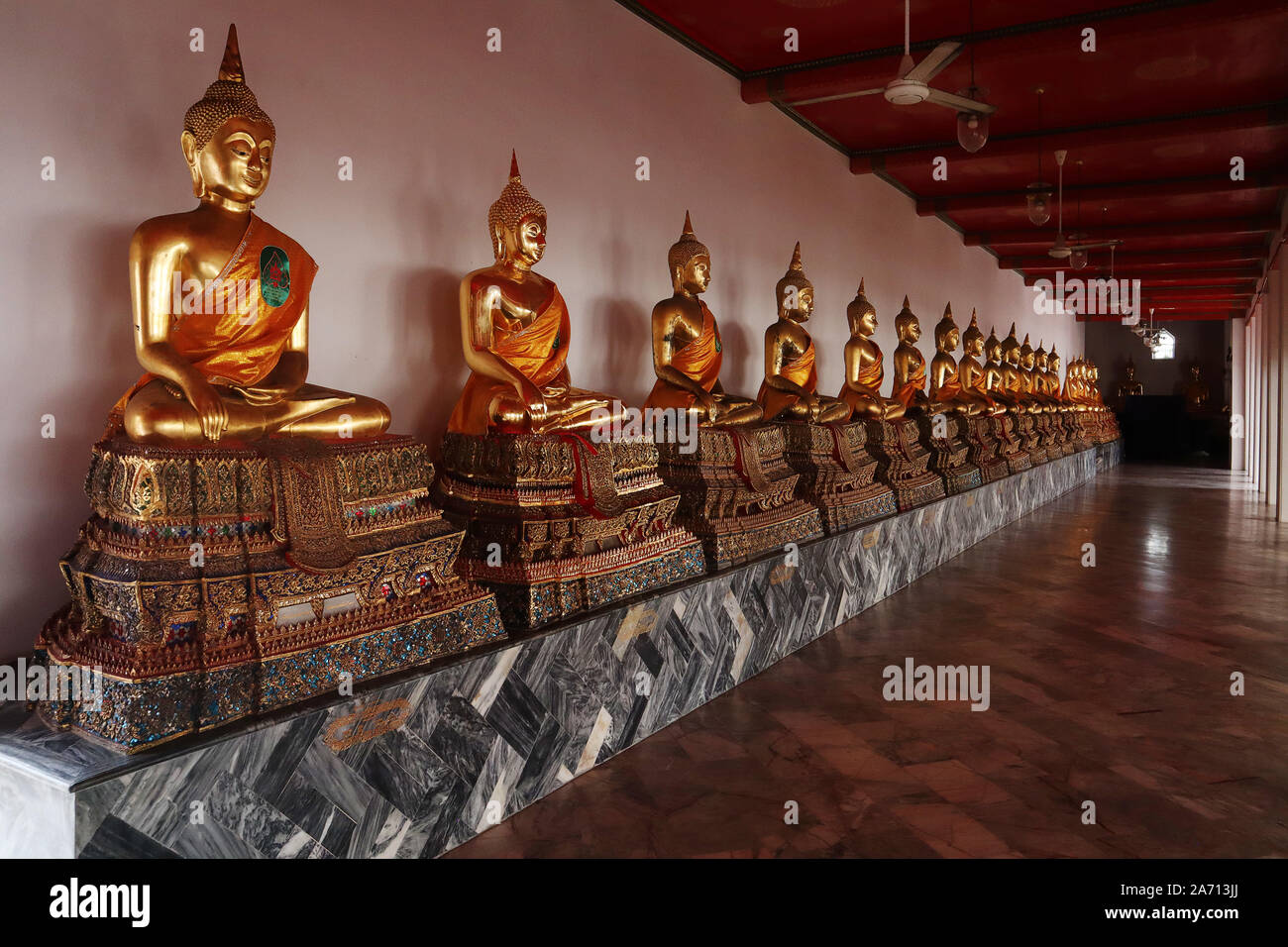 Golden Buddhas line a Temple in Bangkok Stock Photo - Alamy