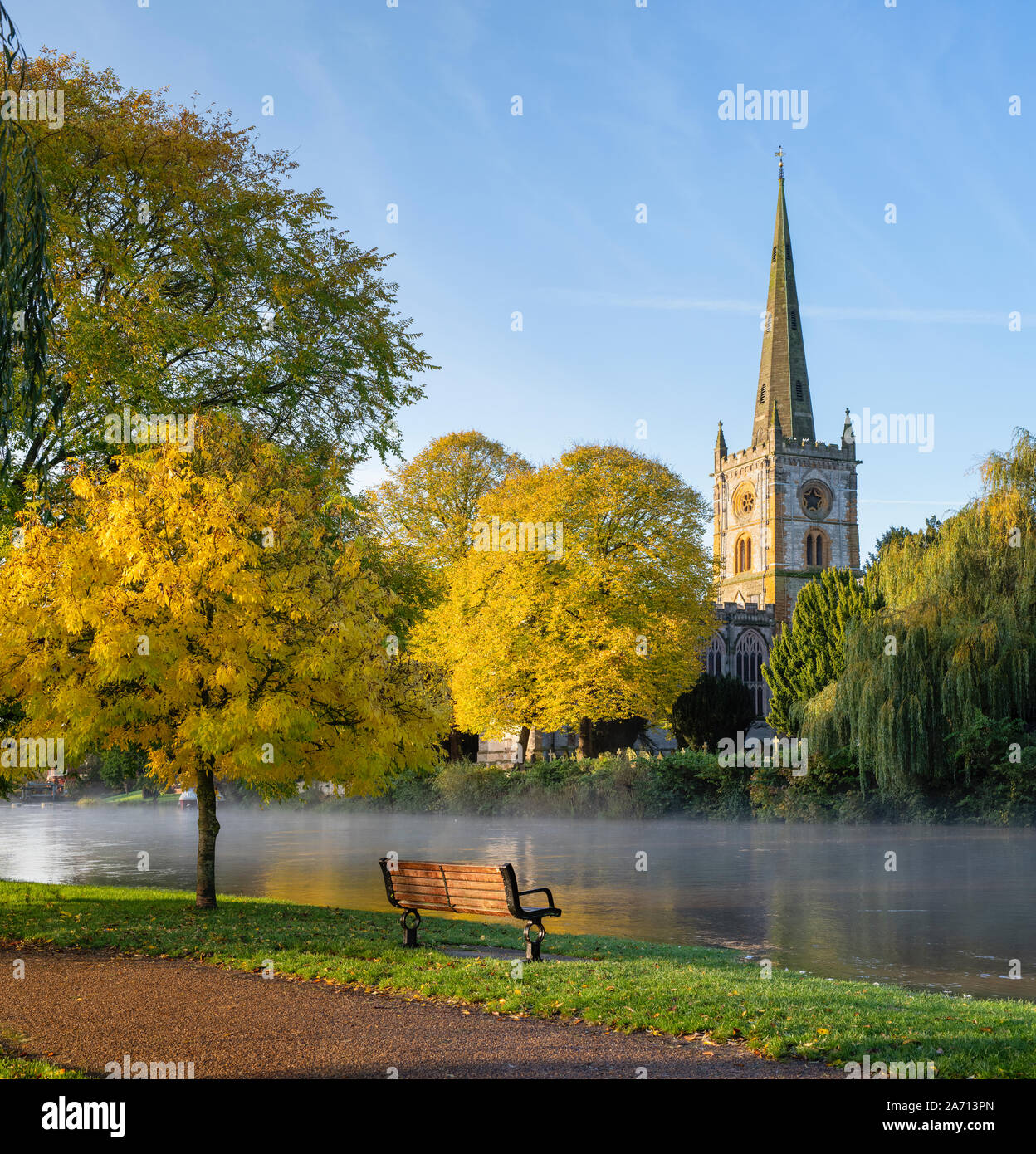 The Holy Trinity Church on the banks of a flooded river avon in autumn. Stratford upon Avon, Warwickshire, England Stock Photo