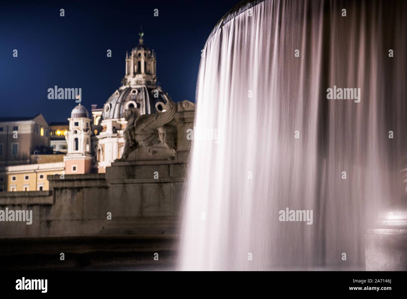 City of Rome Fountains at Night. Famous Fountain of the Tyrrhenian, Piazza Venezia. Italian Architecture. Altar of the Fatherland. Vittorio Emanuele I Stock Photo