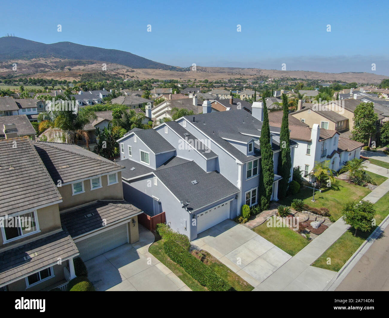 Suburban neighborhood street with big villas next to each other in