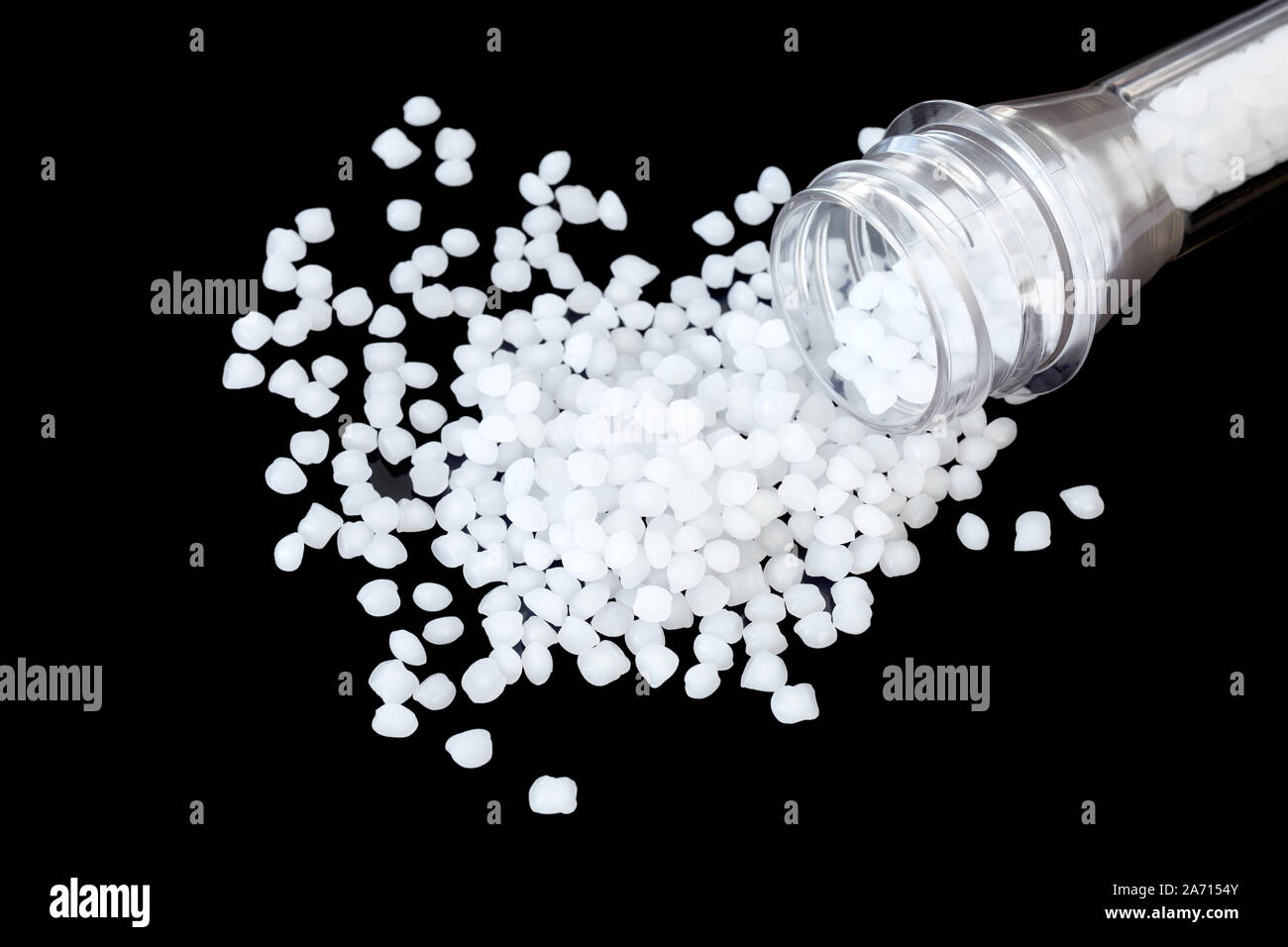 Close up picture of polypropylene (PP) granules isolated on black background, selective focus. Stock Photo