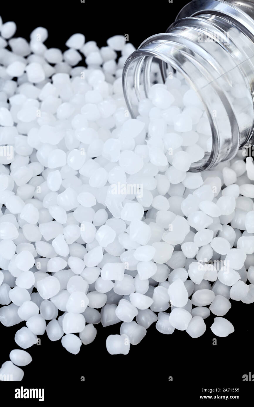 Close up picture of polypropylene (PP) granules on black background, selective focus. Stock Photo
