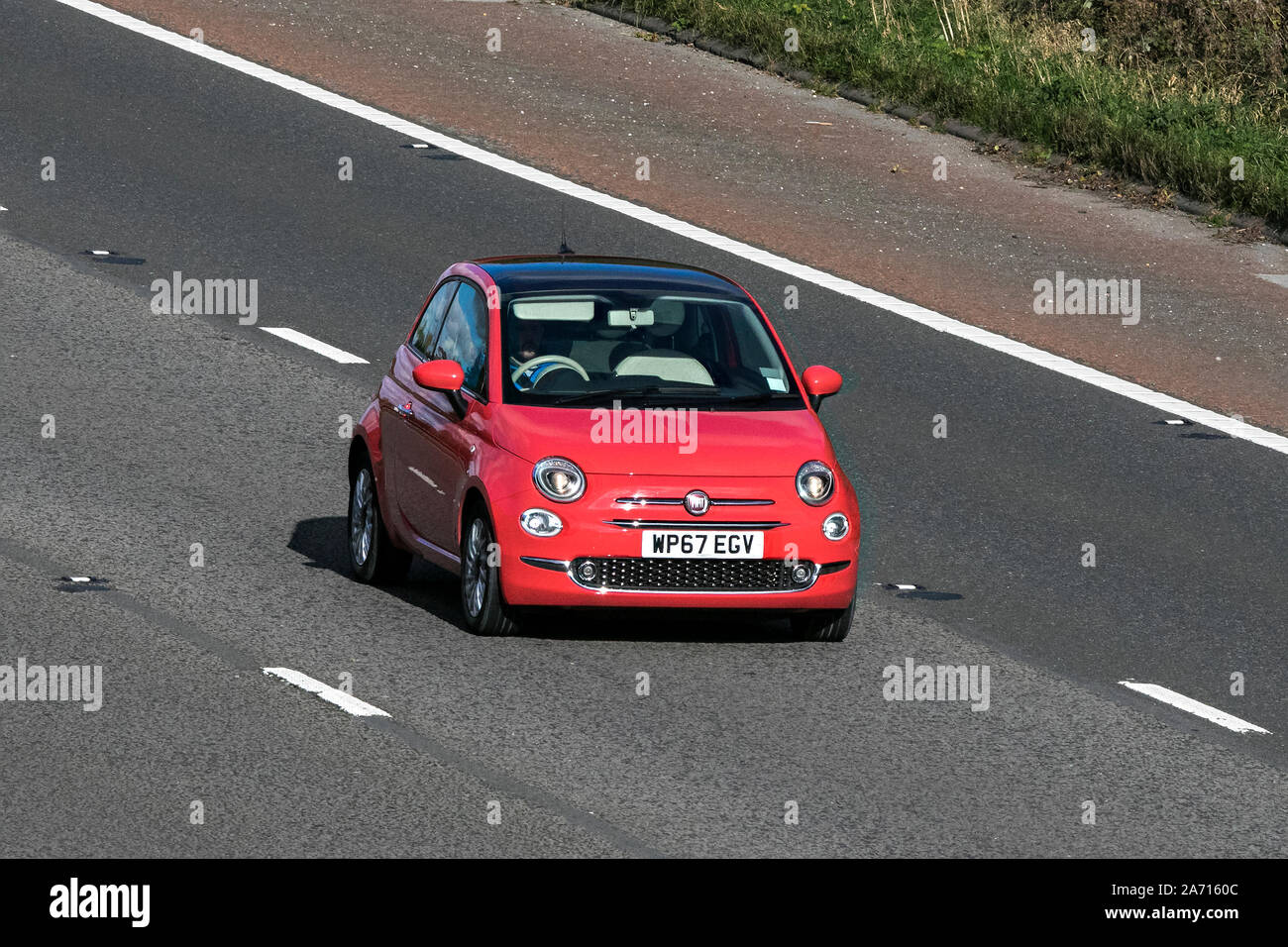 2017 (67) red Fiat 500 Lounge city car; traveling on the M6 motorway near Preston in Lancashire, UK Stock Photo