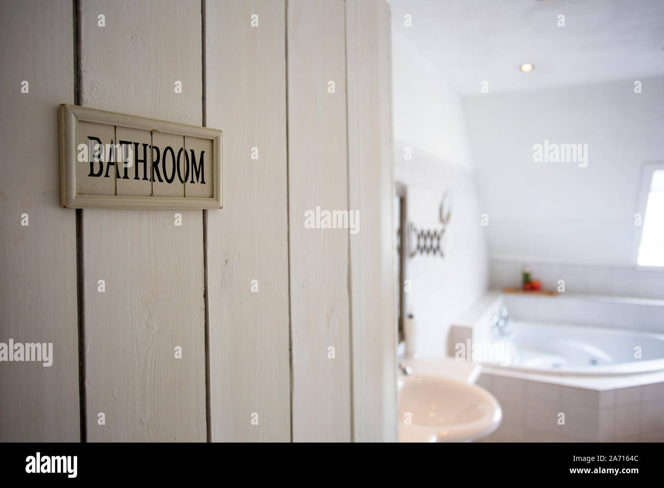 Closeup bathroom door with sign bathroom shallow depth of field, blurred background, white colors Stock Photo