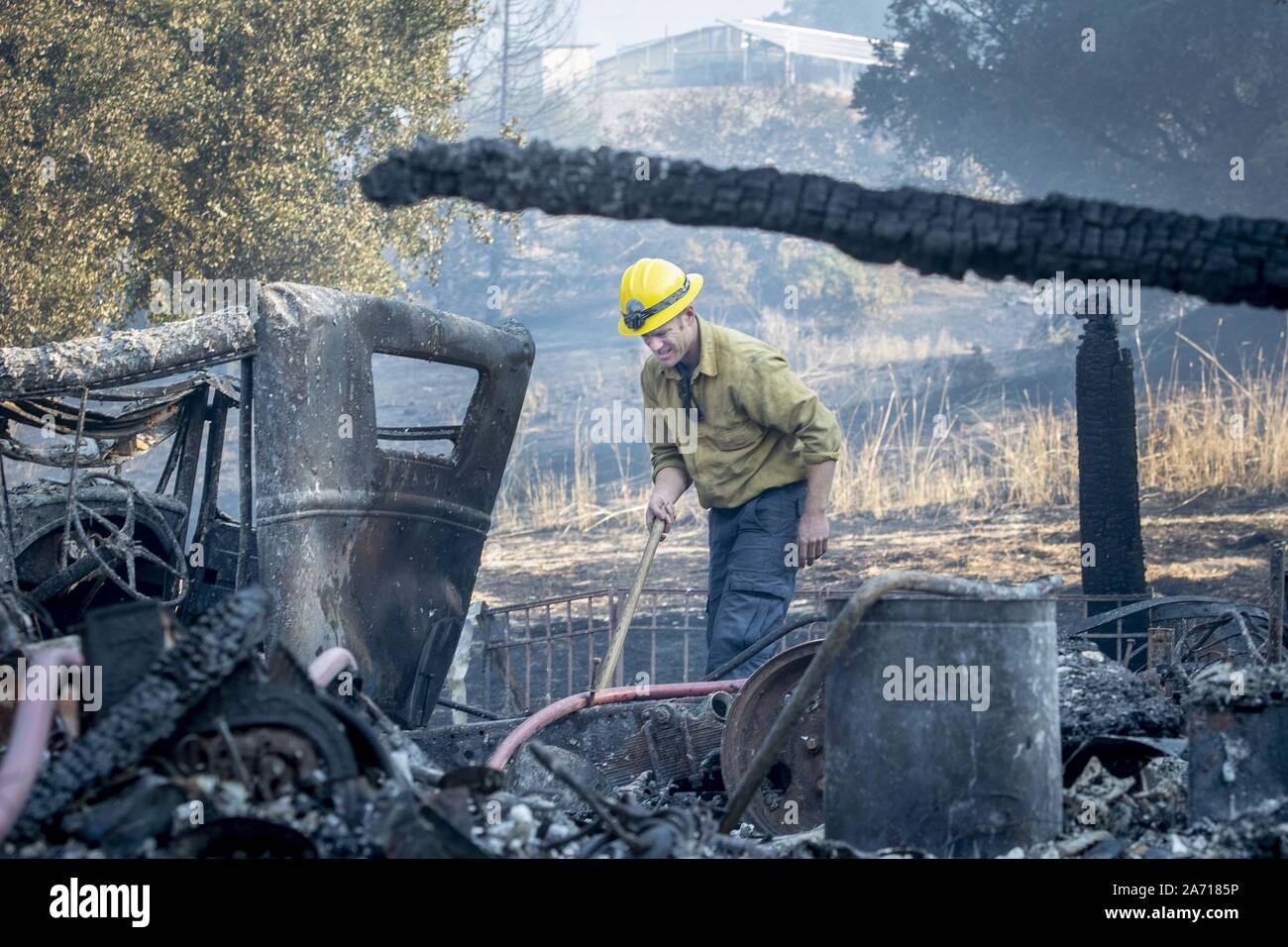 October 29, 2019, Windsor, California: Santa Barbara County Firefighter Shankar Tillotson, mops up a hot spot of a barn that burned Sunday. (Credit Image: © Erick Madrid/ZUMA Wire) Stock Photo