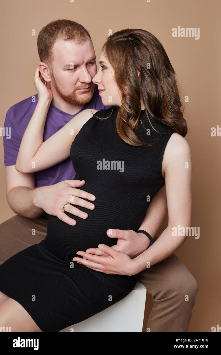 Couple is expecting a baby. Pregnancy and family relations. Loving husband and wife are waiting for the baby