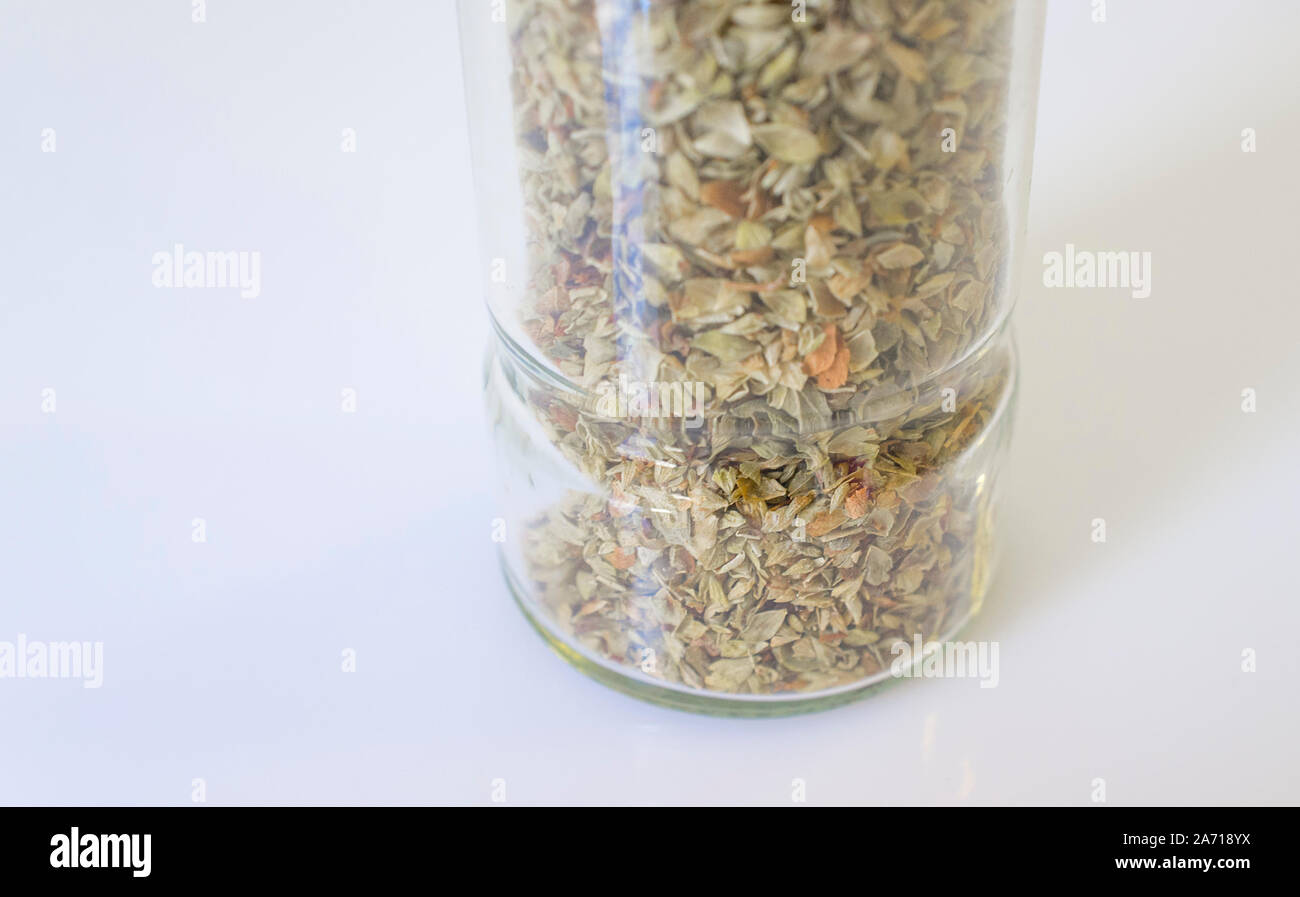 Glass bottle of dry oregano leaves. Closeup Stock Photo Alamy