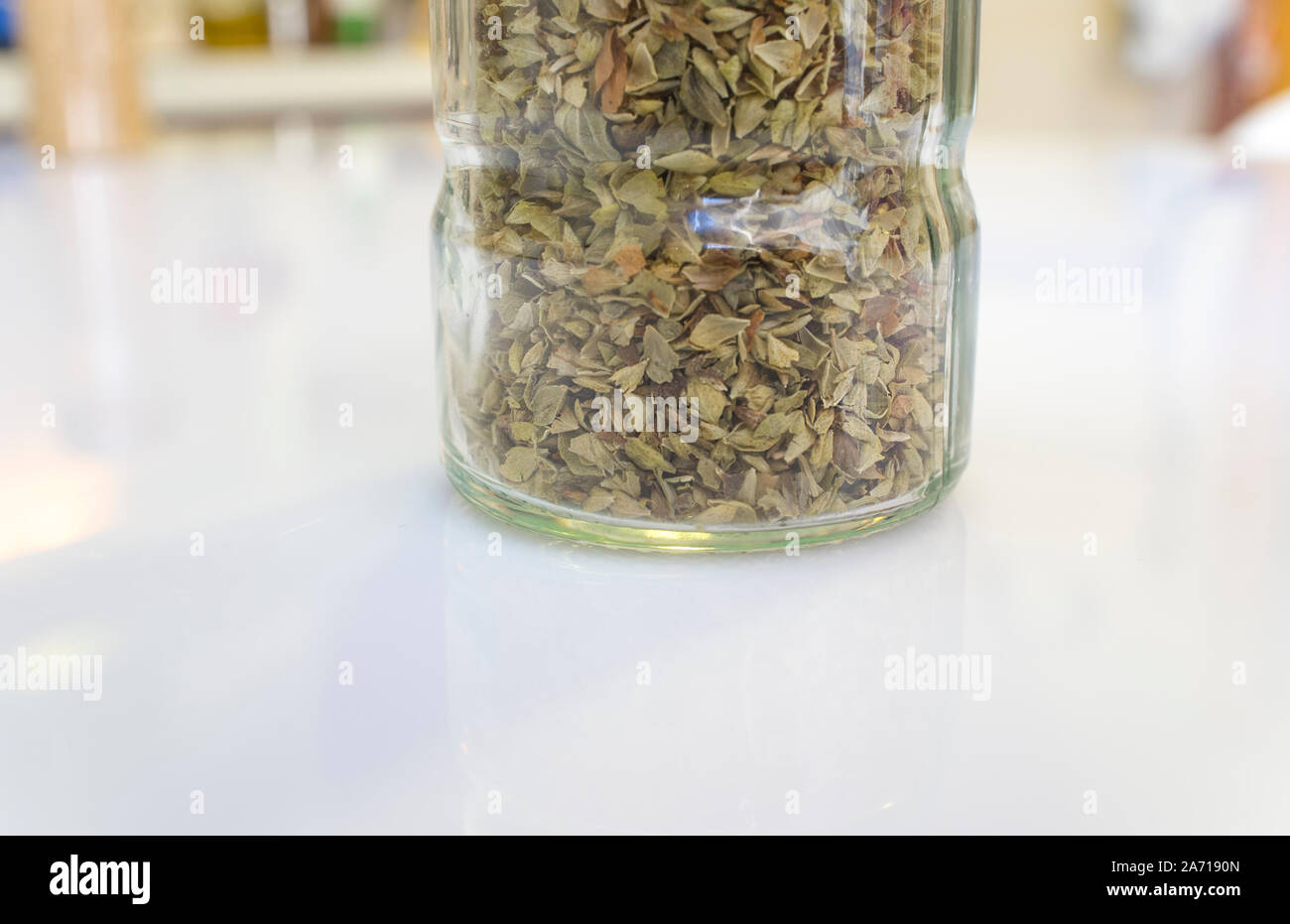 Glass bottle of dry oregano leaves. Closeup Stock Photo Alamy