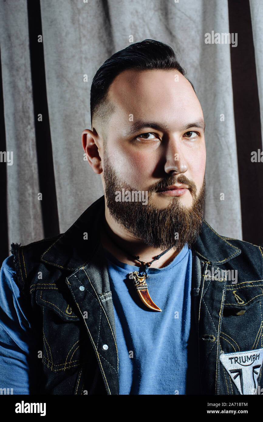Barber shop, a man with a beard cut hairdresser. Professional haircut,  retro hairstyle and styling. Beautiful hair and care, hair salon for men.  Custo Stock Photo - Alamy