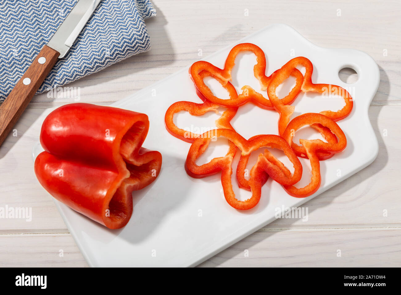 Red bell pepper isolated on cutting board.. Capsicum annuum cultivars Stock Photo