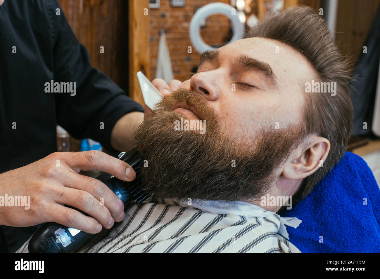 Barber shop, a man with a beard cut hairdresser. Beautiful hair and care, hair salon for men. Professional haircut, retro hairstyle and styling. Custo Stock Photo - Alamy Barber shop, a man with a beard cut hairdresser. Beautiful hair and care, hair salon for men. Professional haircut, retro hairstyle and styling. Custo Stock Photo - Alamy