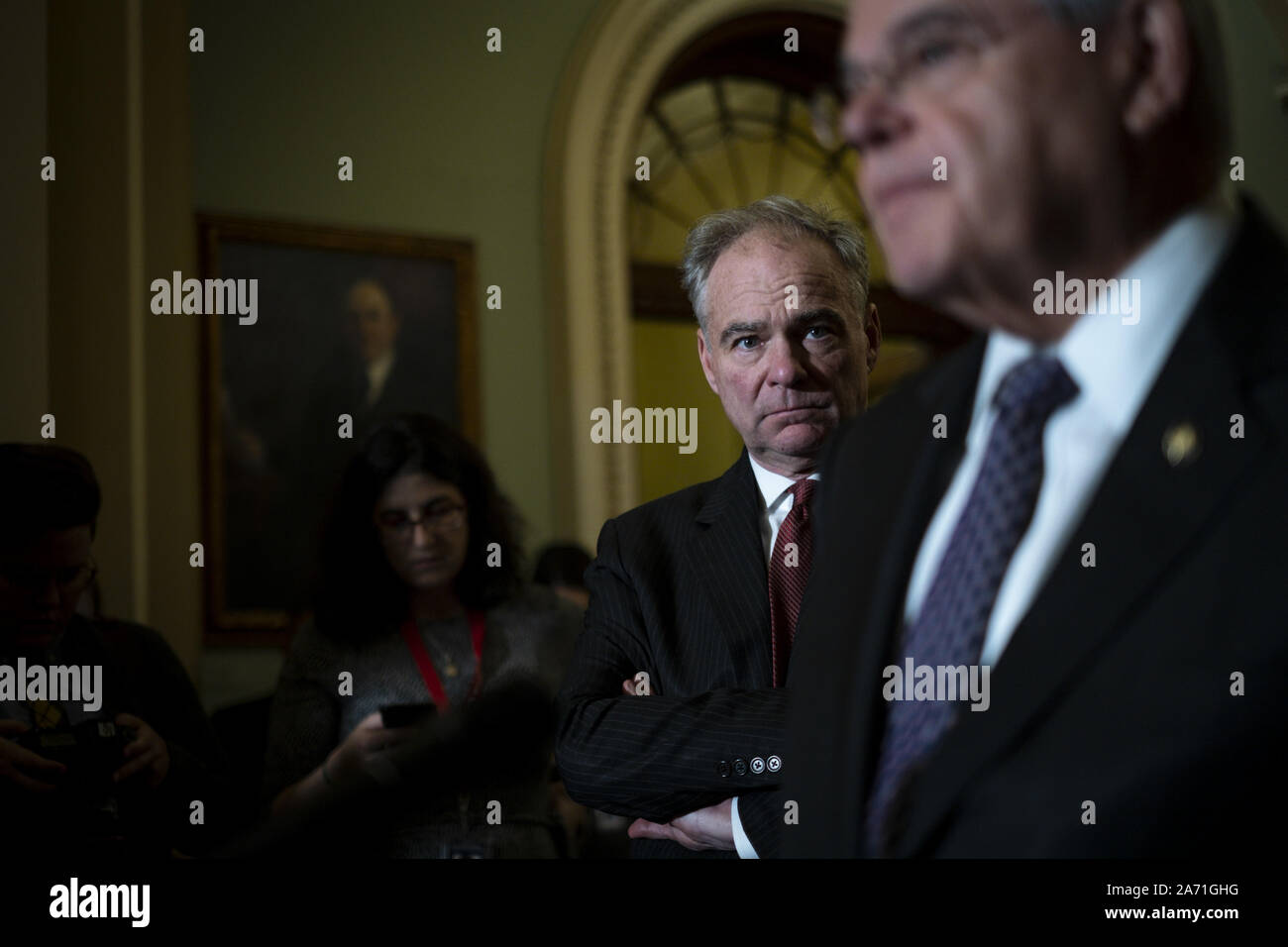 Washington, United States. 29th Oct, 2019. Senator Tim Kaine (D-VA) looks on as Senator Robert Menendez (D-NJ) speak to reporters following the Democrats' weekly policy luncheon in the U.S. Capitol on Tuesday, October 29, 2019 in Washington, DC. Senate Majority Leader, Senator Chuck Schumer (D-NY) said he is 'increasingly worried' that President Trump will shut down the government to distract from the impeachment inquiry. Photo by Pete Marovich/UPI Credit: UPI/Alamy Live News Stock Photo