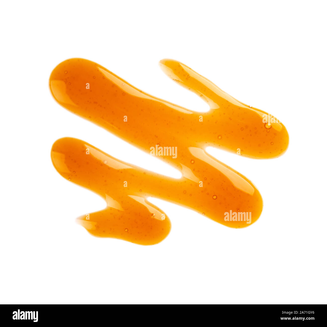 Caramel syrup drizzle isolated on white background. Splashes of sweet