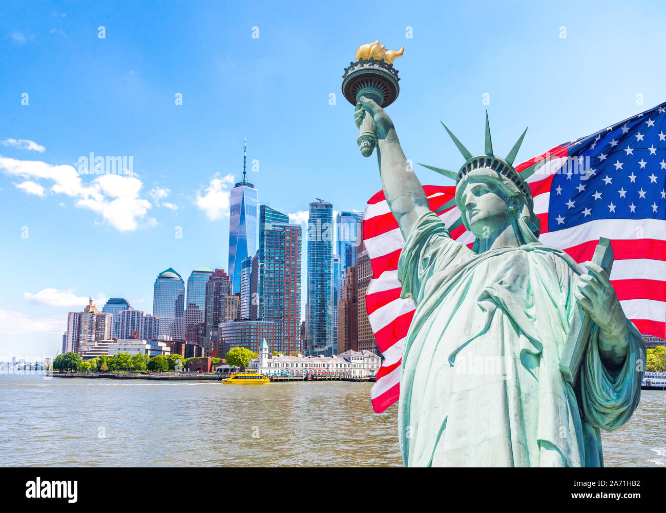 Statue of Liberty with large american flag in the background. Stock Photo