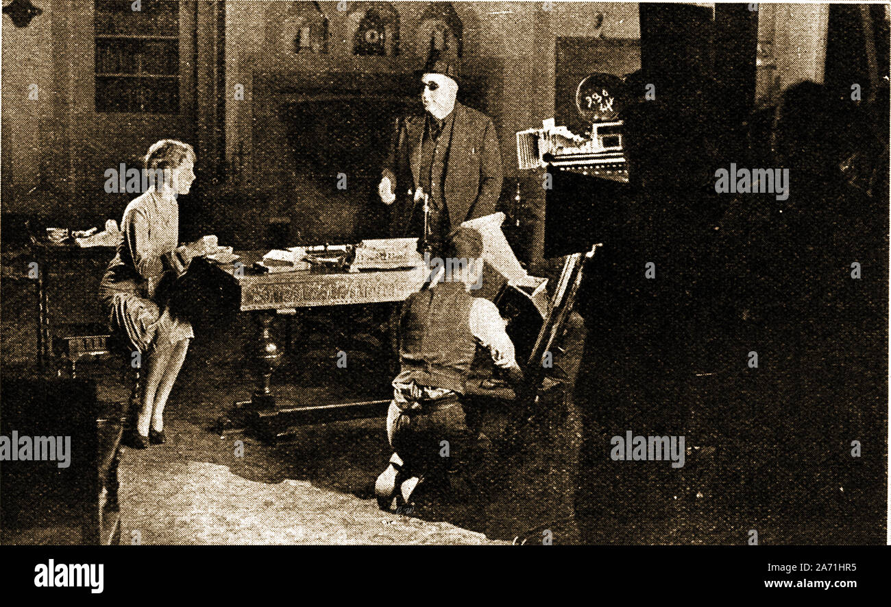A 1940's scene at Elstree Film Studios (British International Pictures) , England 1940's - novelist Edgar Wallace (dark glasses) directs a scene. Stock Photo
