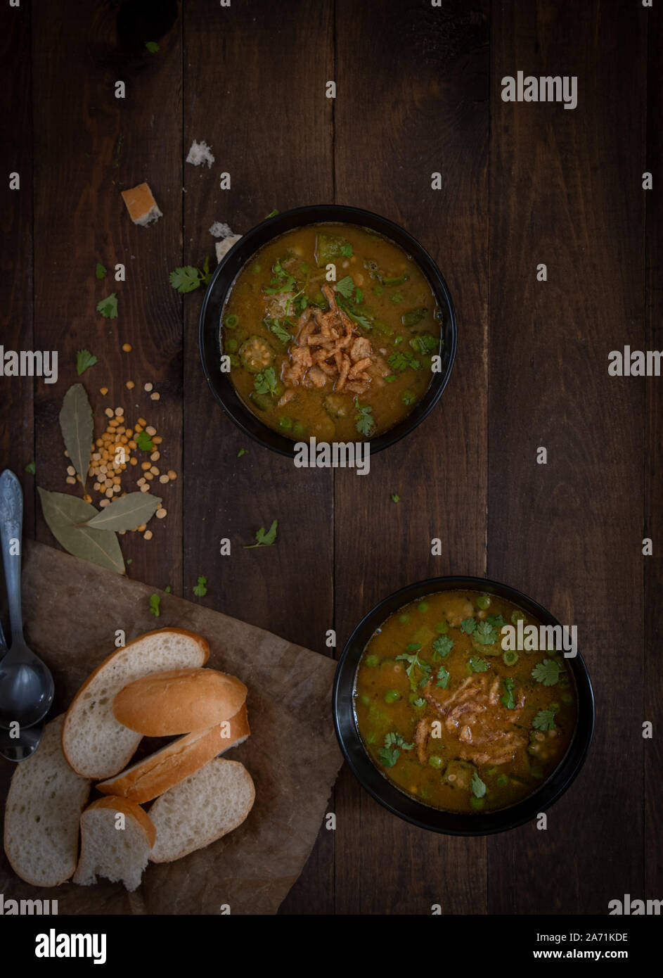 Vegan lentil, okra and peas soup, topped with crispy onions, served in