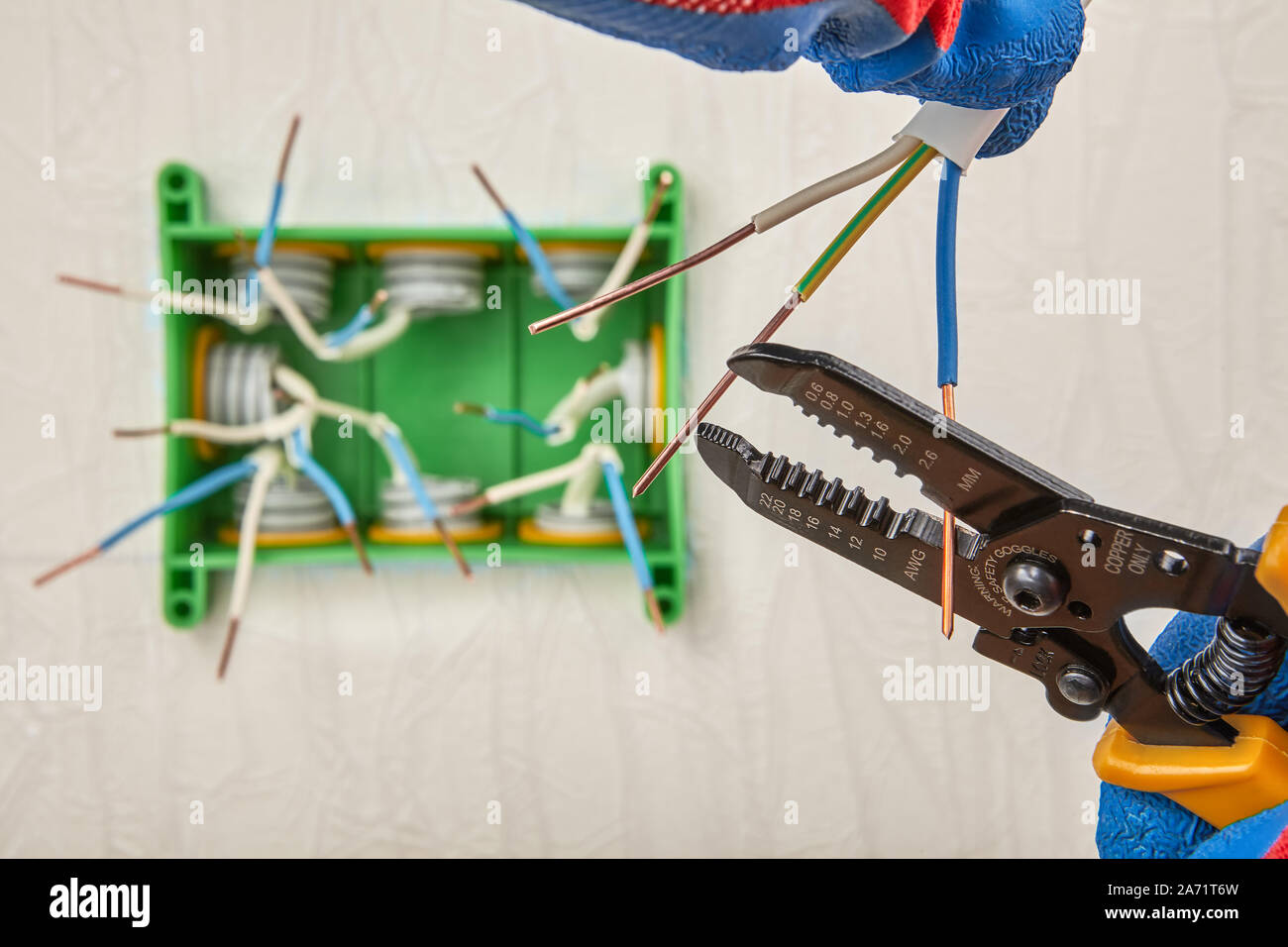 Cutting wires with wire cutter pliers. Installation of a square plastic