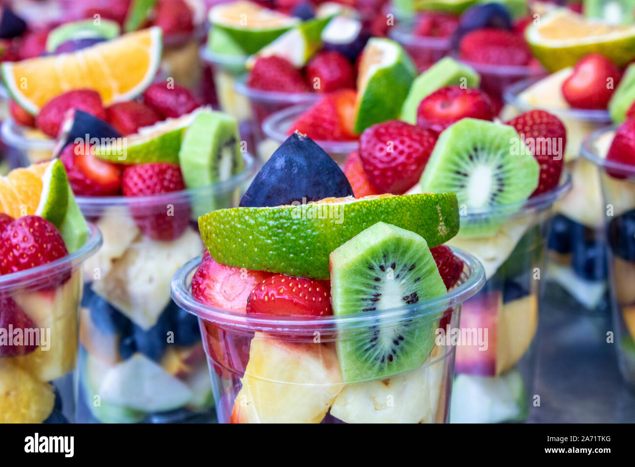 Sliced Fruits In Plastic Cups Bench On Sale Stock Photo