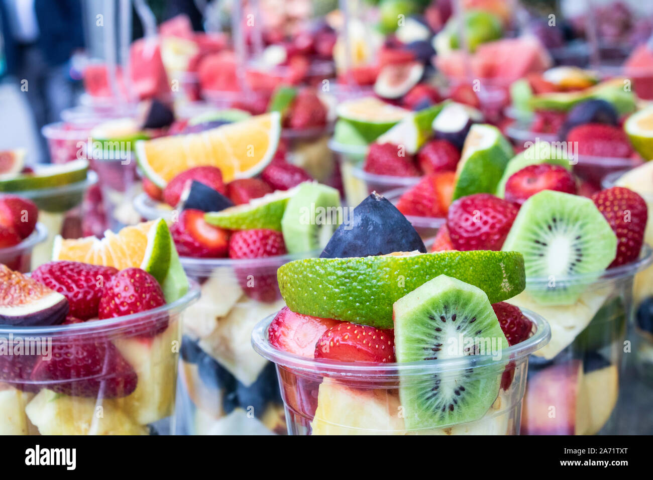 Sliced Fruits In Plastic Cups Bench On Sale Stock Photo