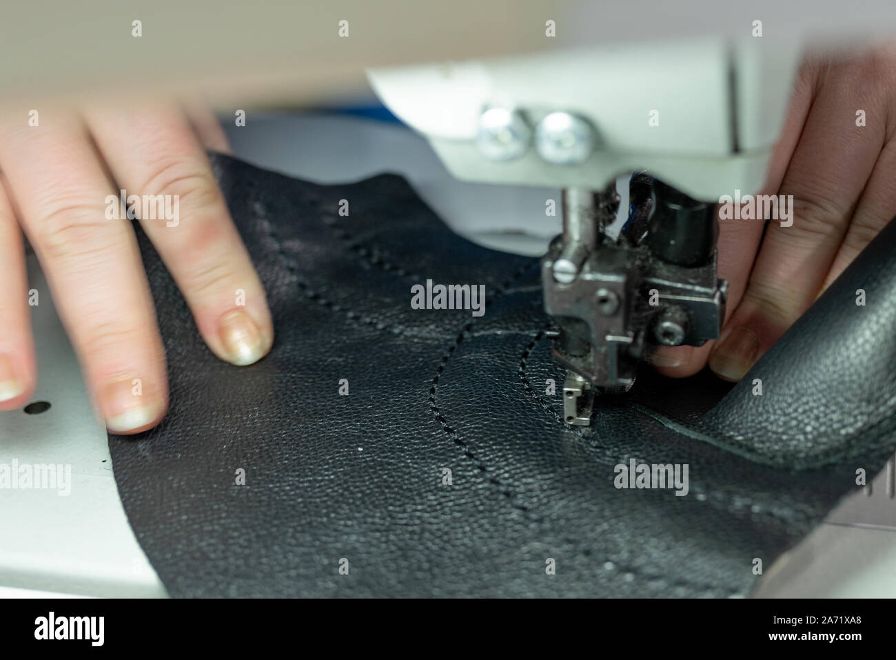 The process of sewing shoes on a sewing machine. Shoe production Stock