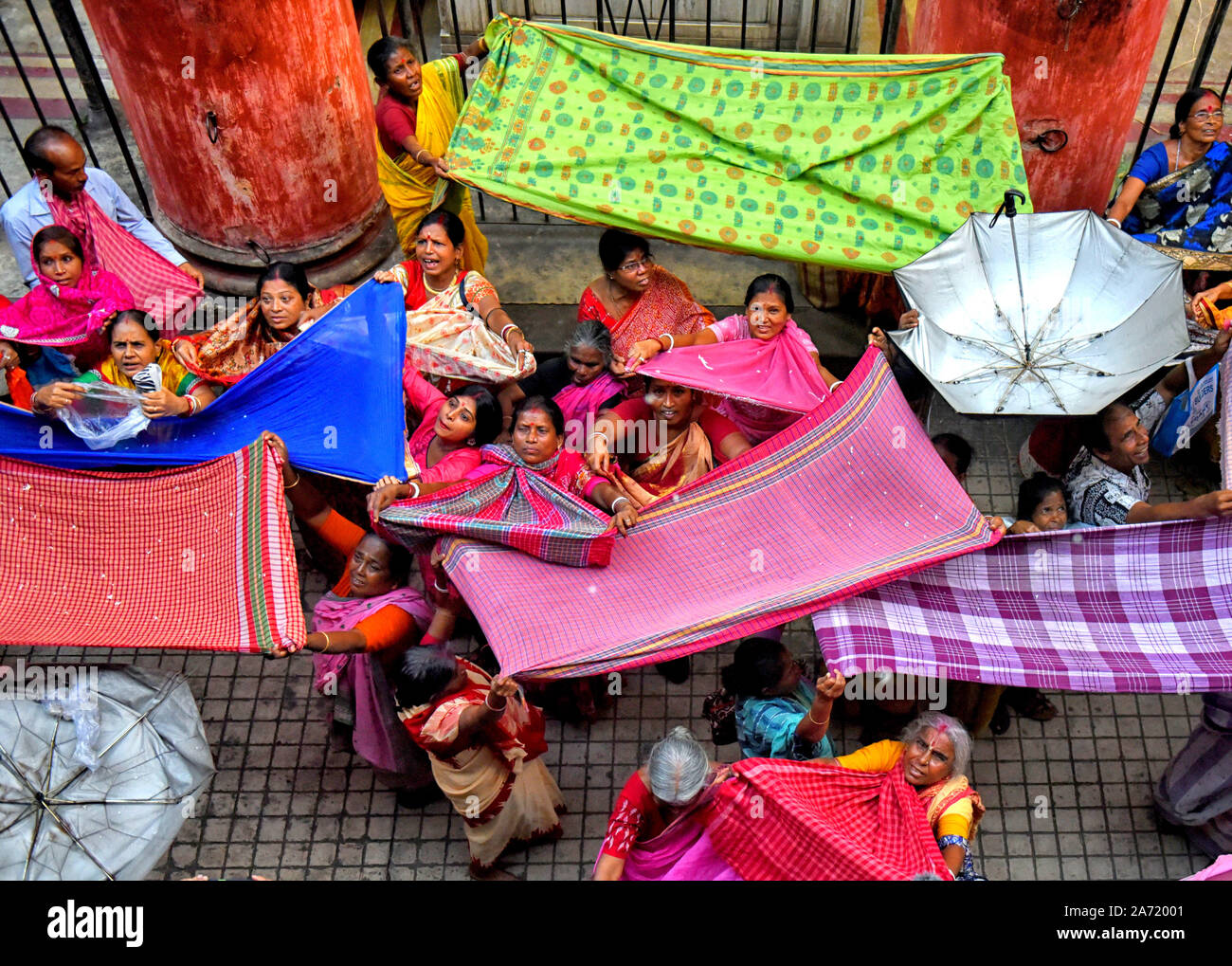 Hindu devotees collecting the auspicious offerings from Madanmohan ...