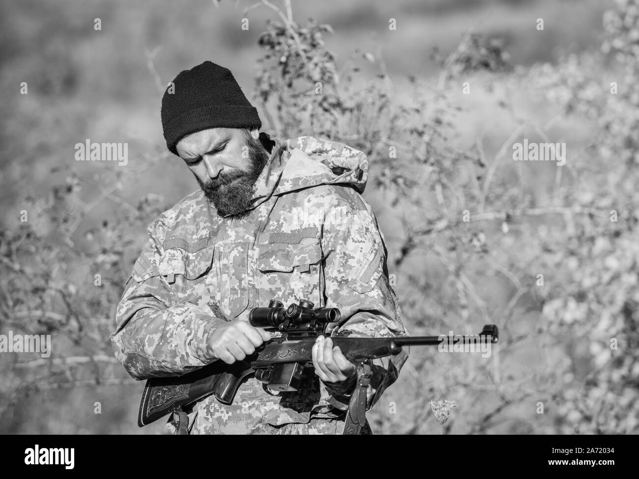Man aiming target nature background. Hunter hold rifle. Aiming skills