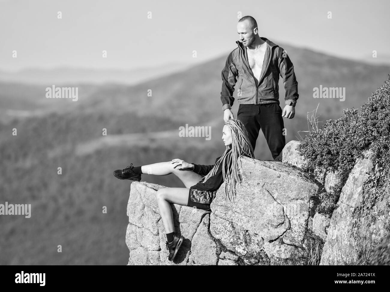 On Edge Of World Woman Sit Edge Of Cliff High Mountains Landscape Background Couple Hikers Enjoy View Hiking Peaceful Moment Tourist Hiker Girl And Man Relaxing Hiking Benefits Hiking Weekend Stock Photo