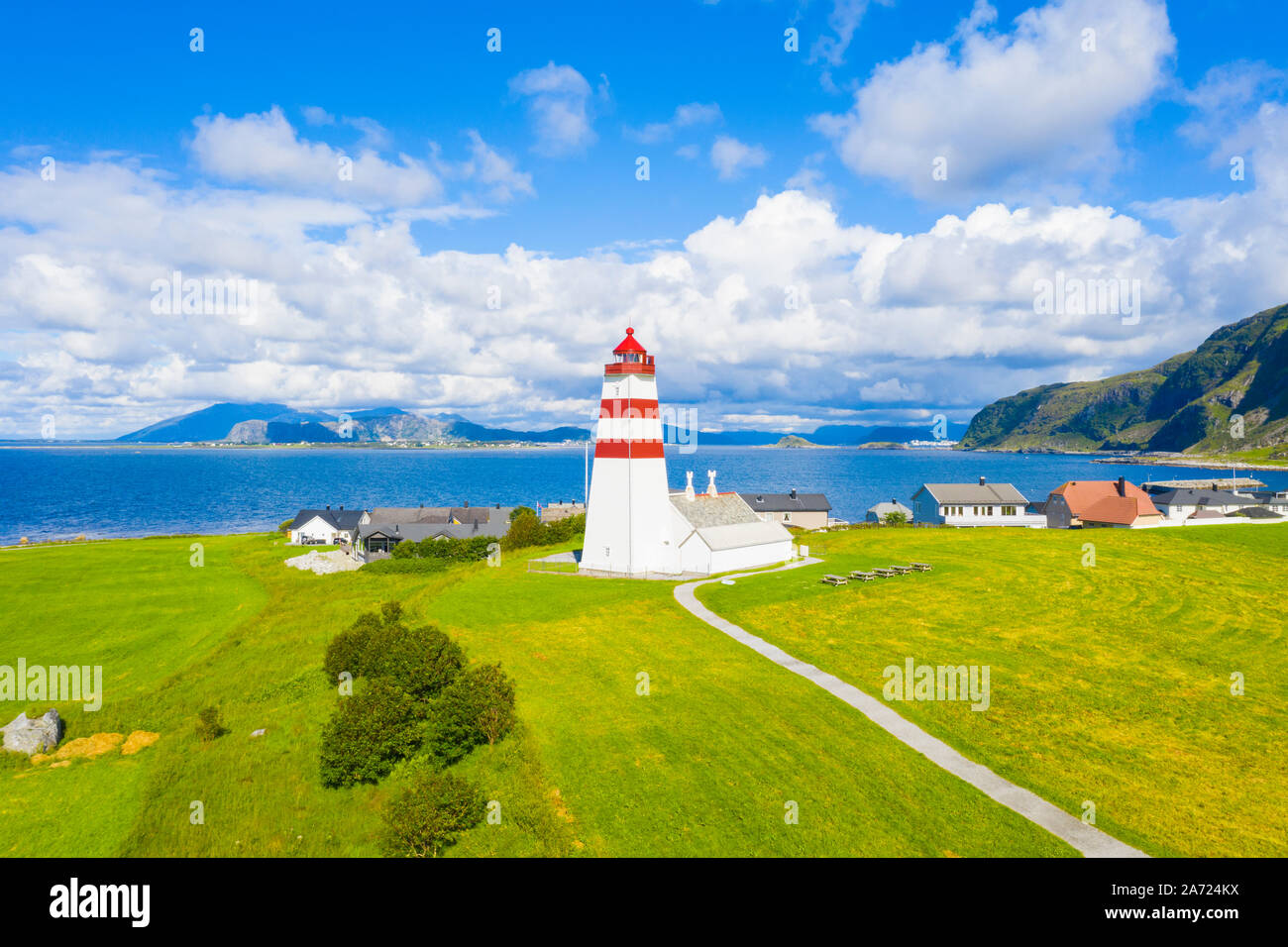 Aerial view of Alnes Lighthouse between meadows and sea, Godoya Island, Alesund, More og Romsdal County, Norway Stock Photo