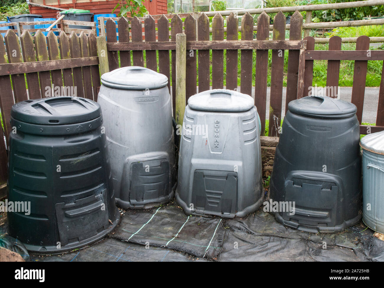 Compost bins on an allotment used for recycling green waste leaves and kitchen waste Stock Photo