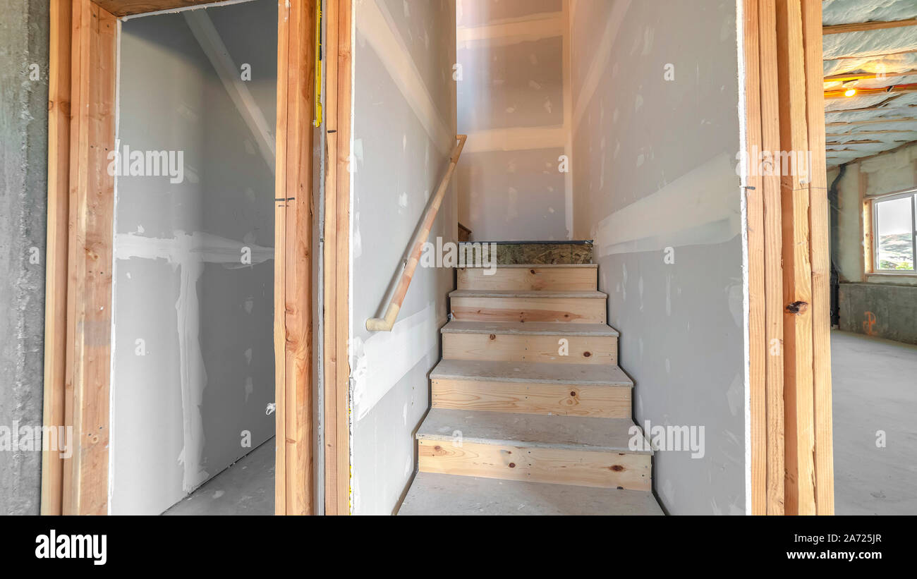 Panorama frame Under construction wooden stairs in a basement Stock