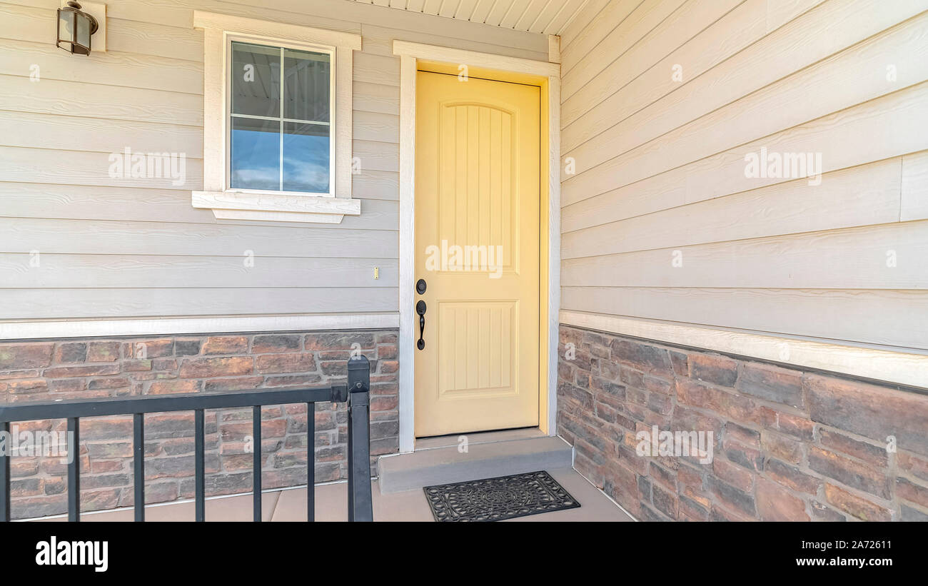 Panorama frame Front porch of suburban home with a yellow door Stock ...