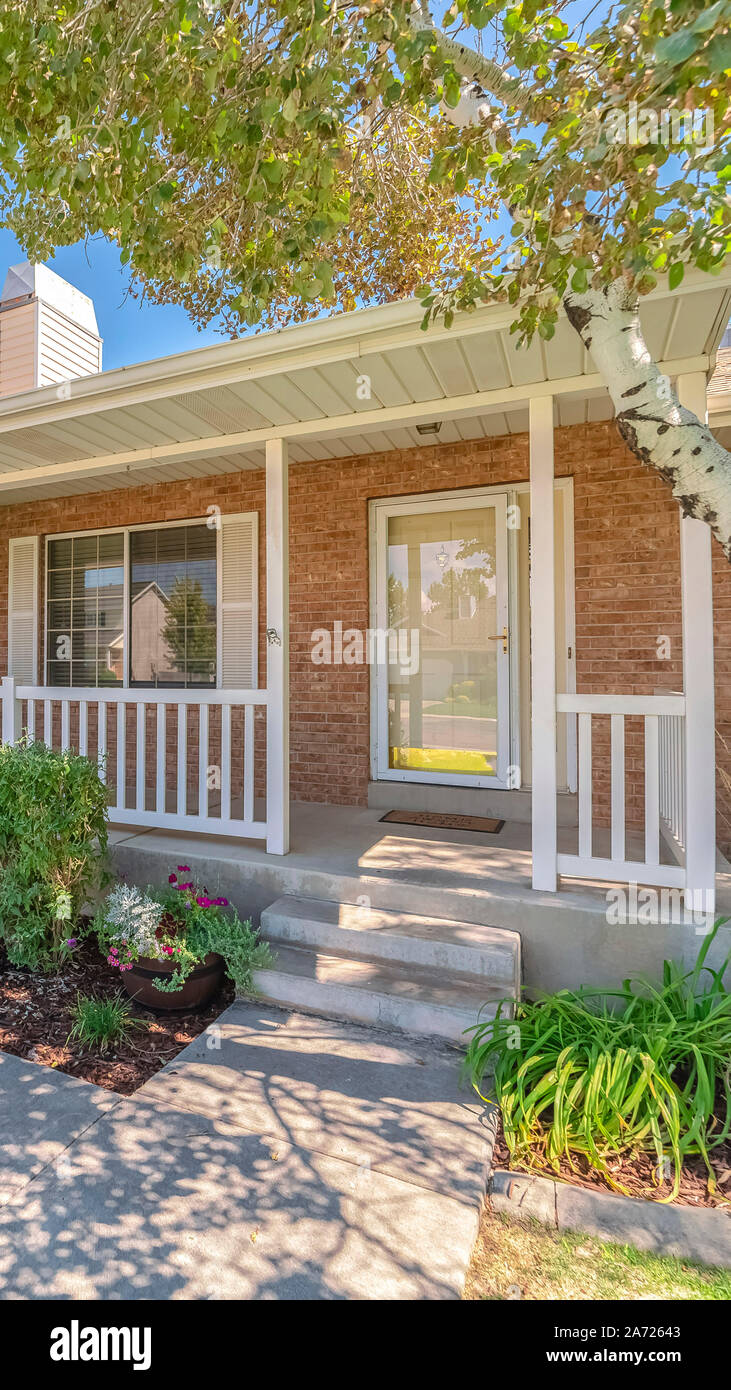 Vertical Exterior and garden of traditional brick home Stock Photo - Alamy