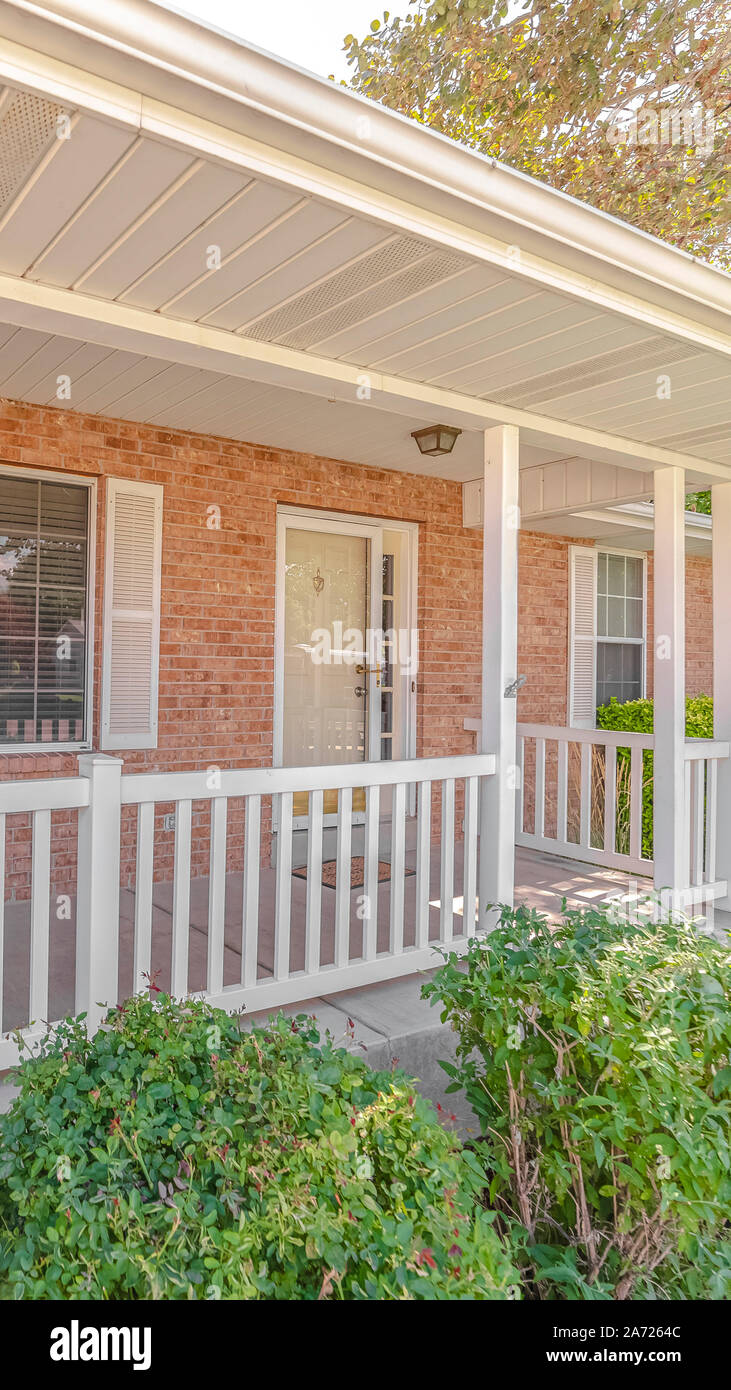 Vertical Front porch and garden of traditional brick home Stock Photo ...