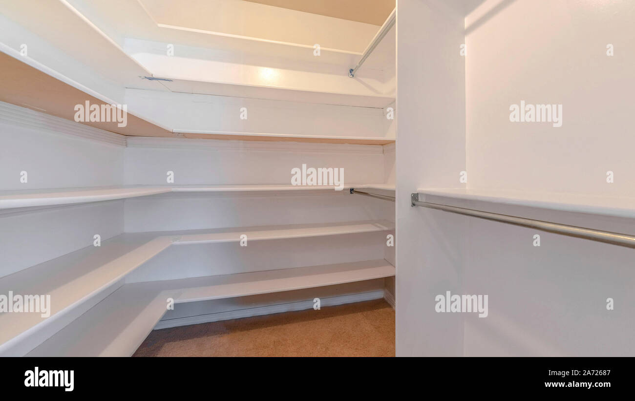 Panorama A white walk in closet with empty shelves Stock Photo - Alamy