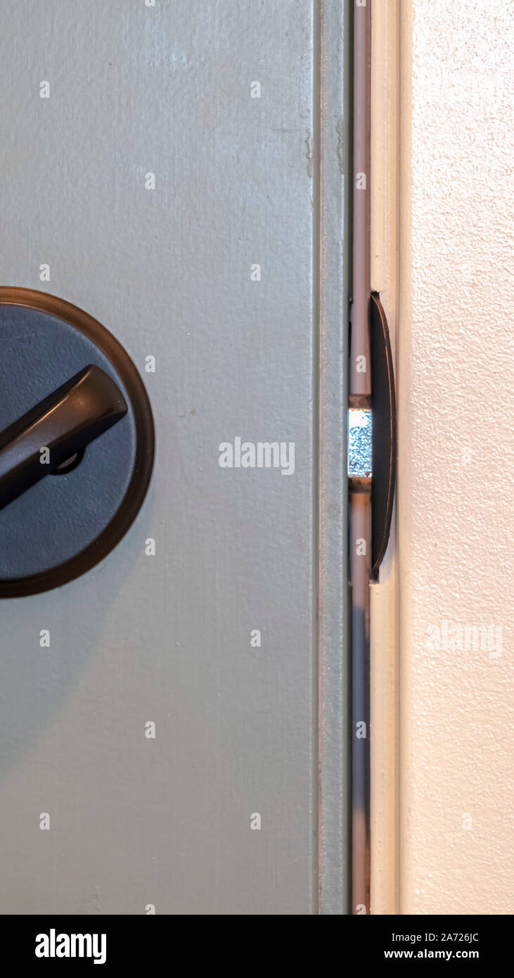 Vertical frame Close up of locked deadbolt latch on home door Stock