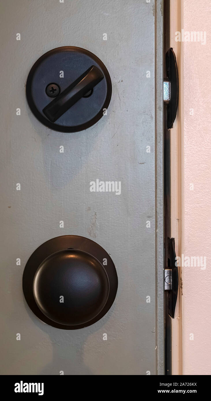 Vertical frame Close up of black door knob and locked latch Stock Photo Alamy