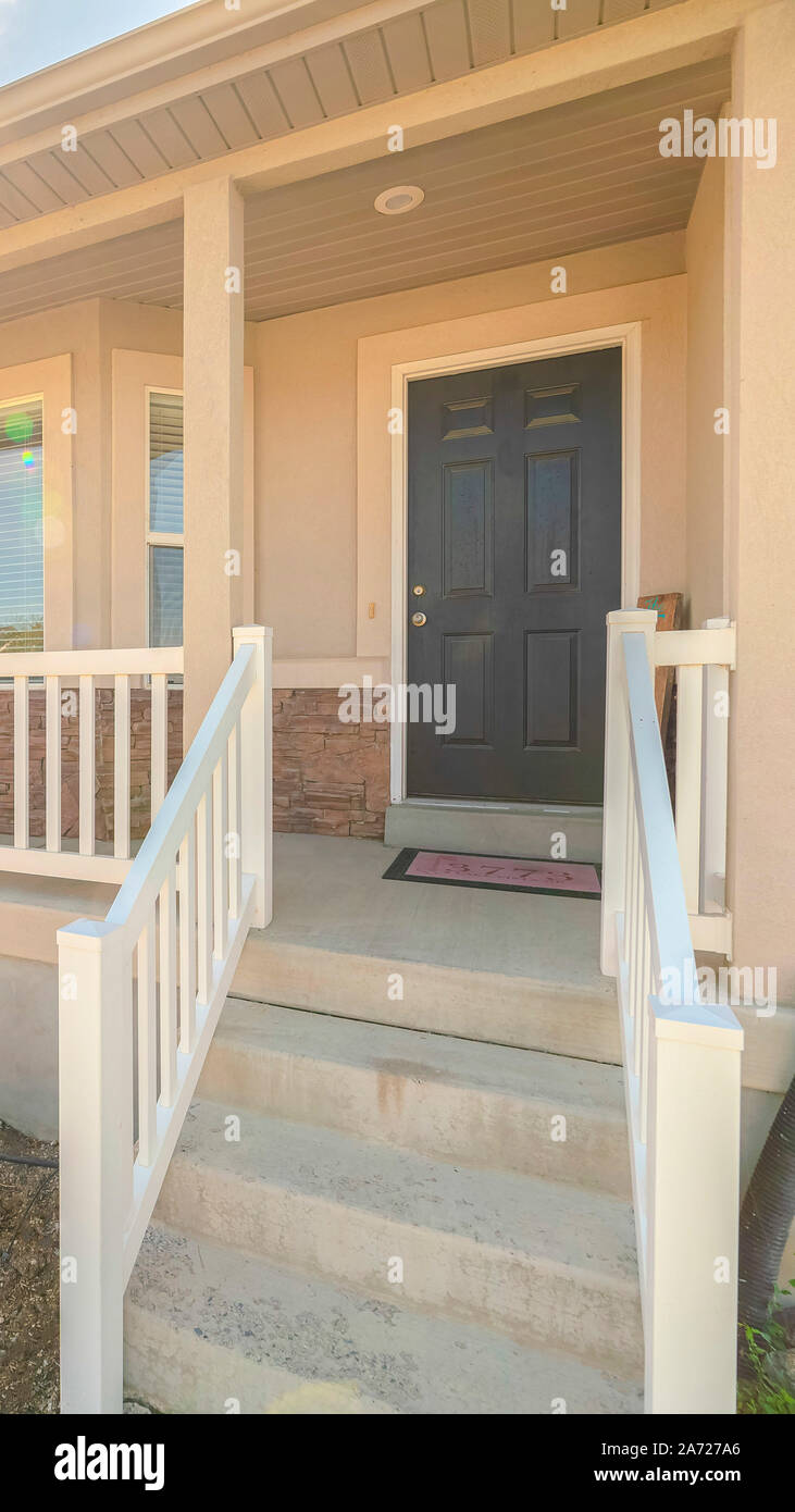 Vertical frame Front porch of suburban home with American flag Stock ...