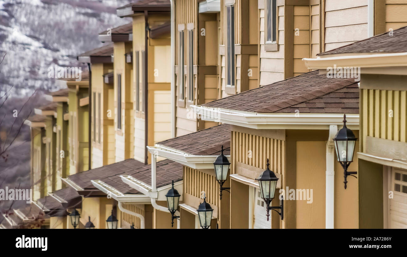 Panorama Close Up Of Townhouses Exterior With Wide Garage