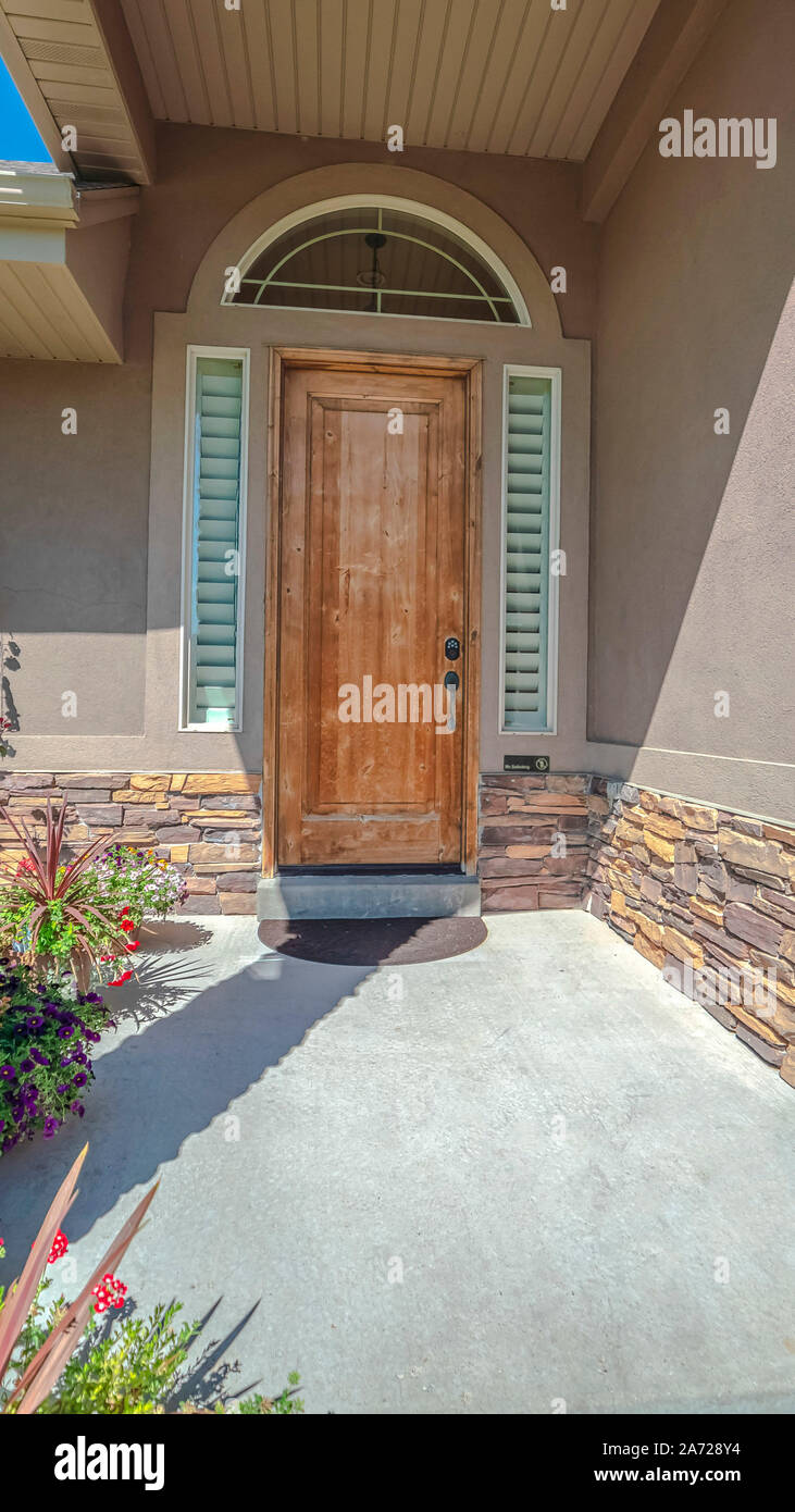 Vertical Front porch and door of house with stone pillars Stock Photo ...