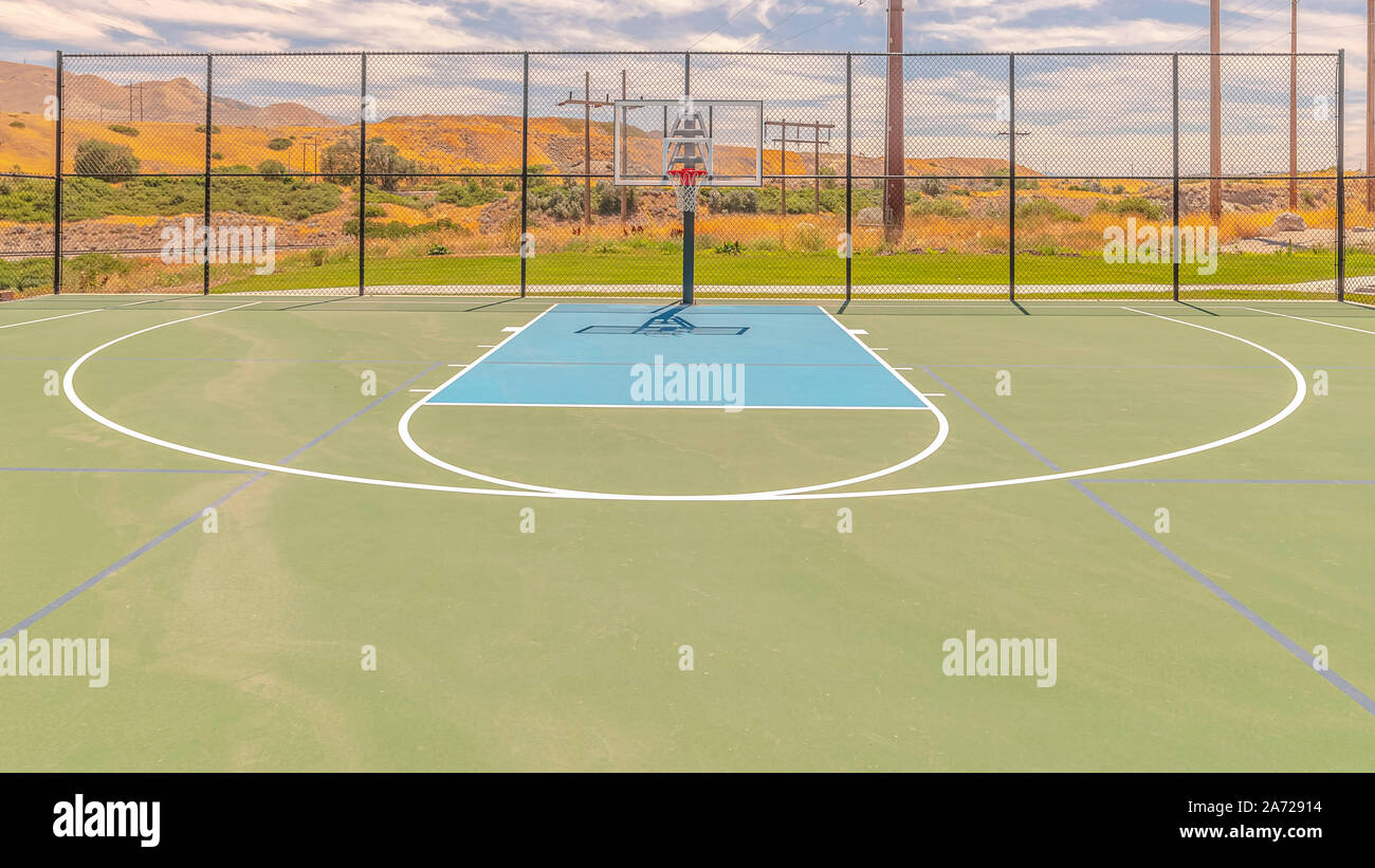 Panorama frame Outdoor basketball court on sunny, blue day Stock Photo