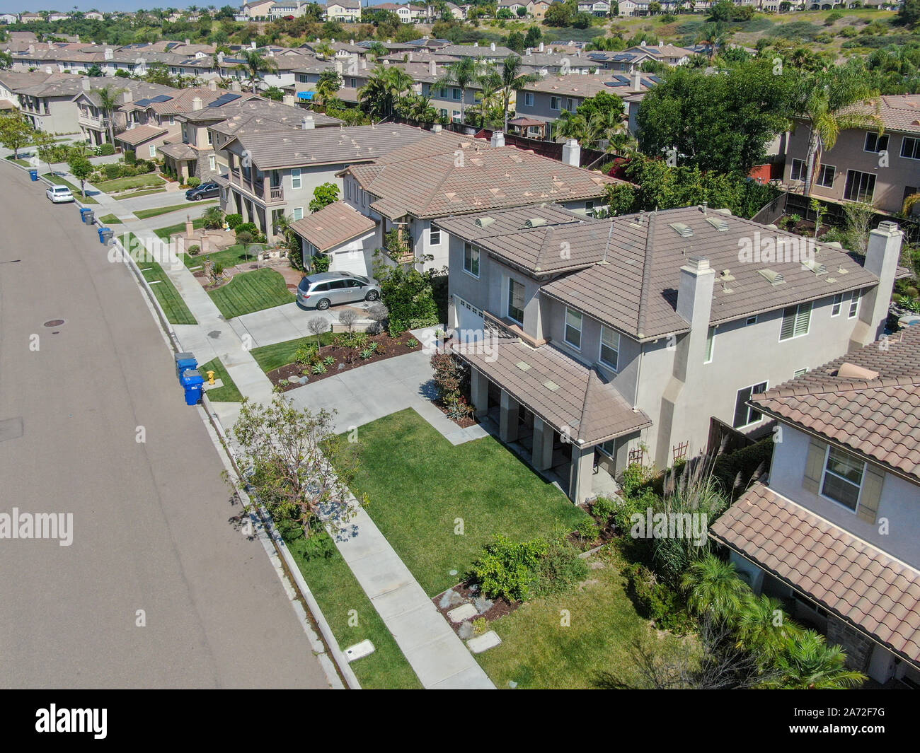 Suburban neighborhood street with big villas next to each other in