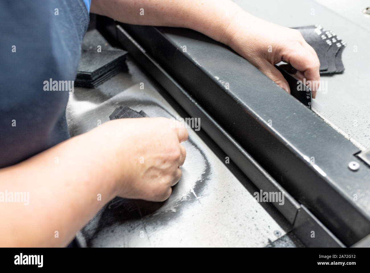 Lowering the edges of parts. Shoe production. Stock Photo