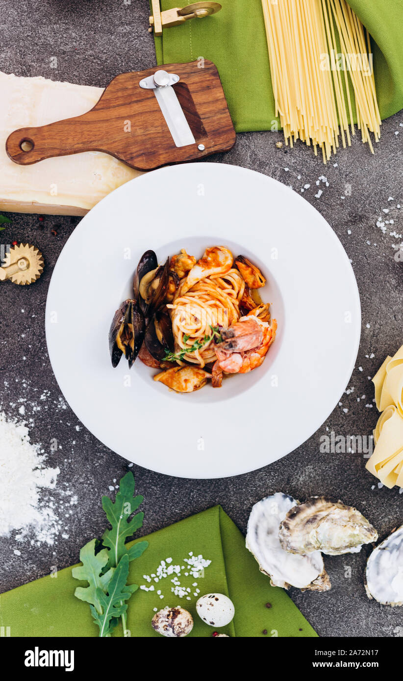 Pasta with mussels and shrimp in sauce. Italian dish. Stock Photo