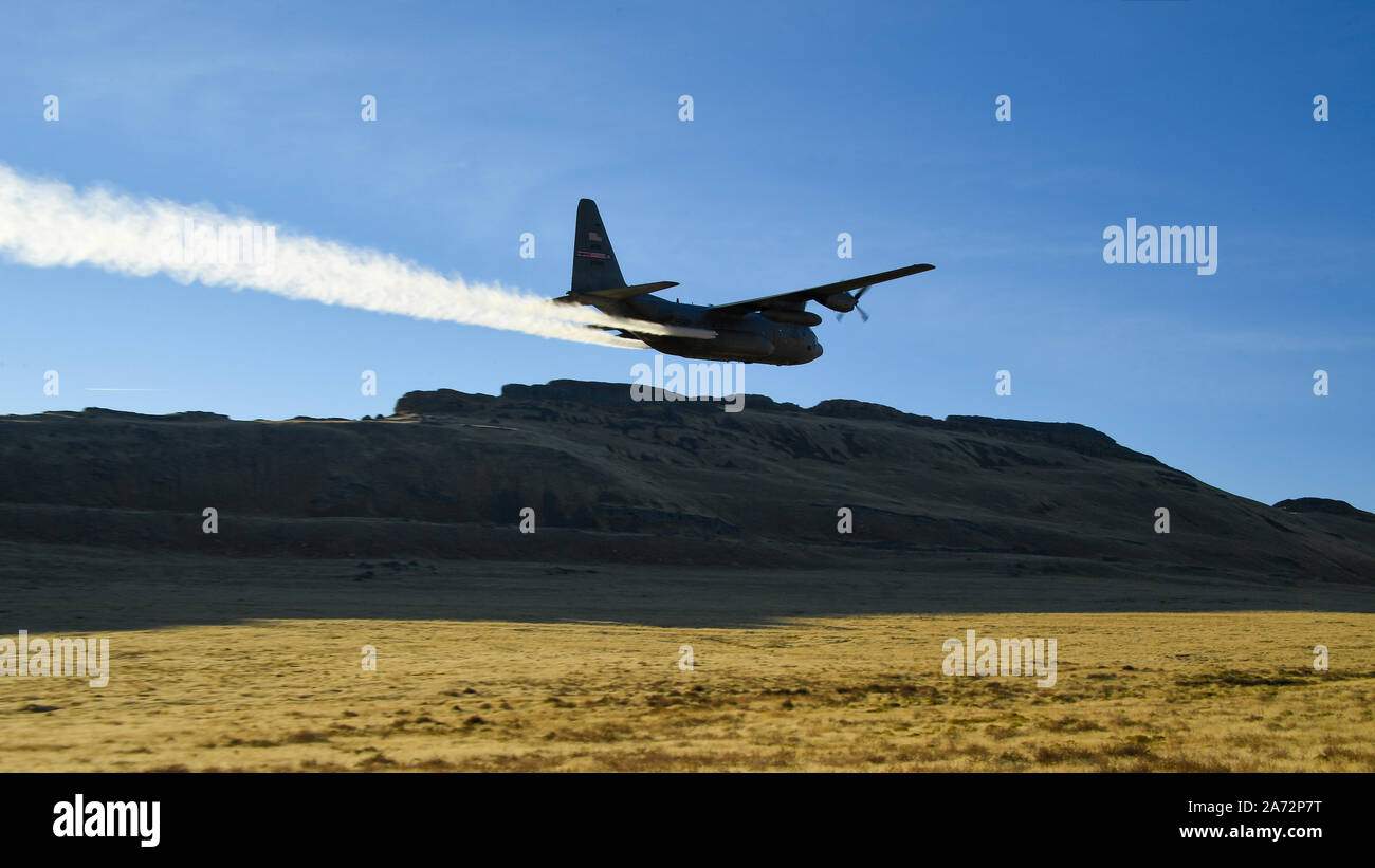 A C-130 Hercules assigned to the Air Force Reserve 757th Airlift Squadron flies over the Utah Test and Training Range Oct. 24, 2019, during an aerial spray operation. The aircraft sprayed invasive vegetation to establish new and expand existing firebreaks on the range in areas inaccessible to work crews due to unexploded ordnance hazards. (U.S. Air Force photo by R. Nial Bradshaw) Stock Photo