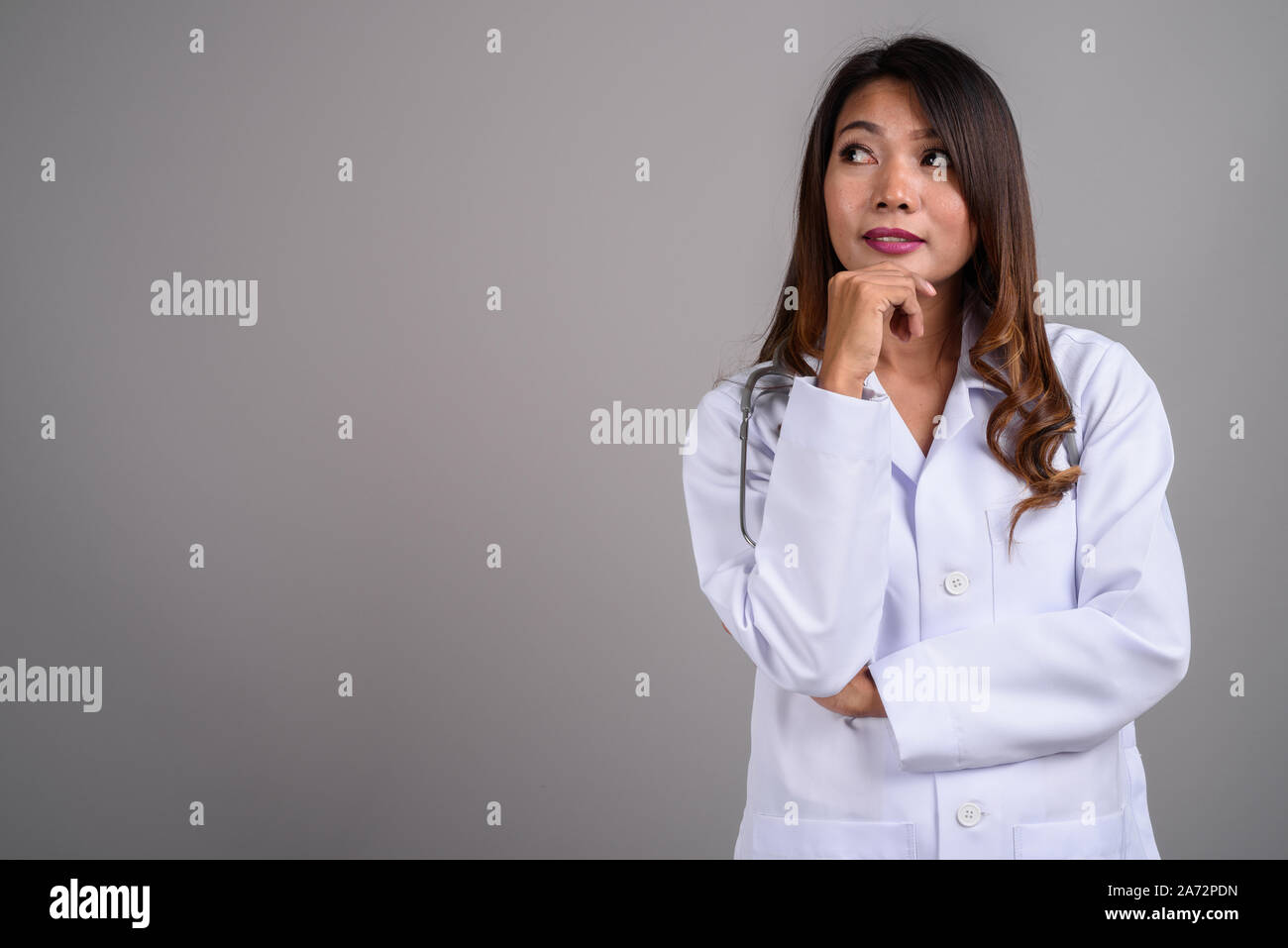 Portrait of Asian woman doctor with wavy hair Stock Photo - Alamy