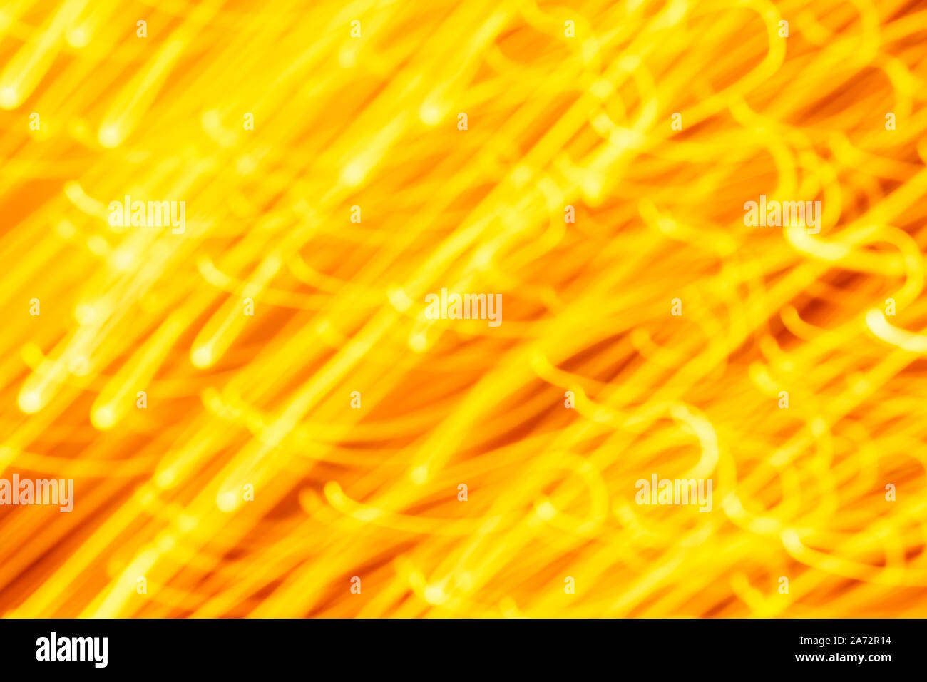 Futuristic blurred lights holiday monochrome background in yellow. Horizontal, soft focus Stock Photo