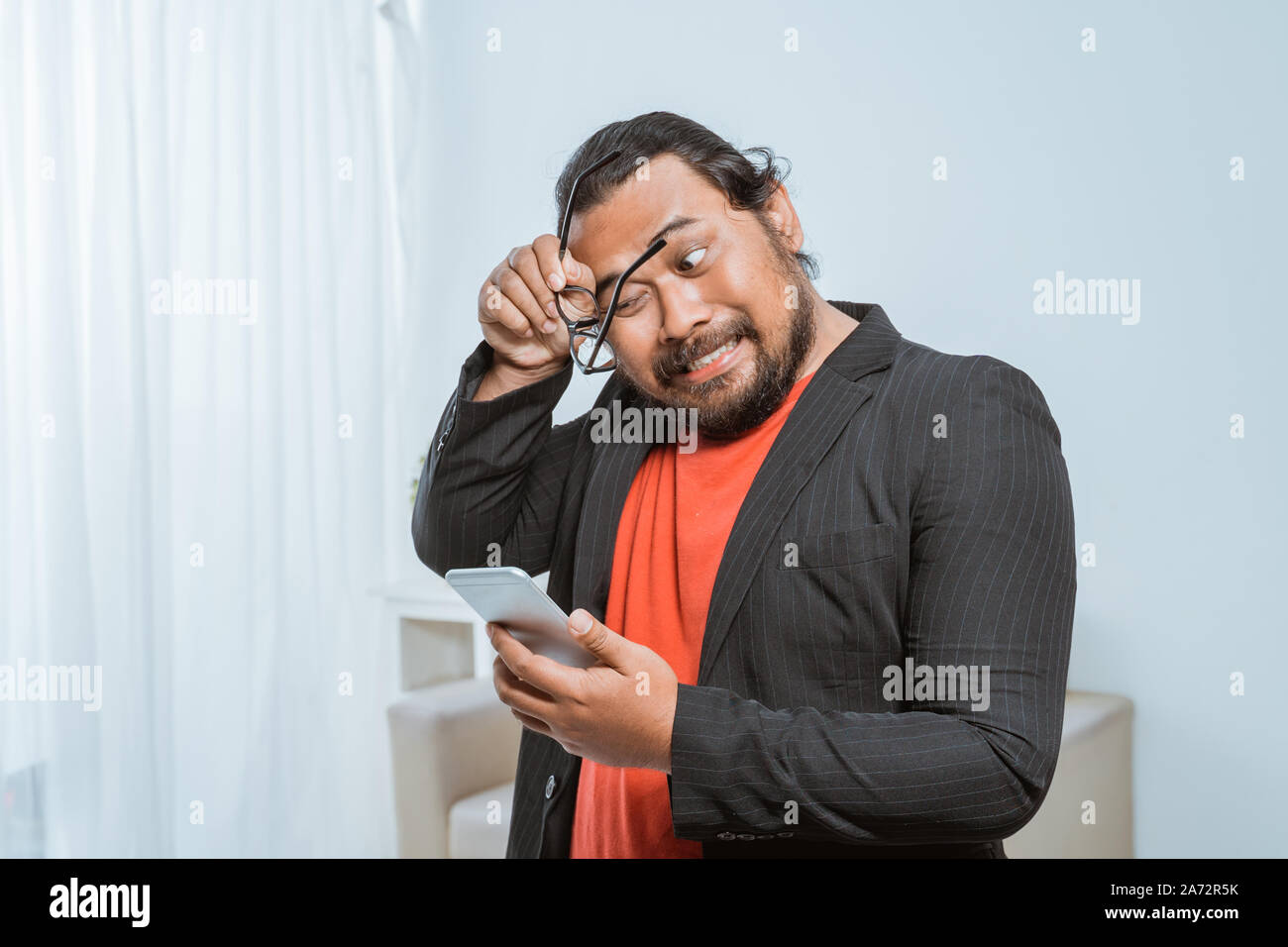 stress businessman holding his phone at the office Stock Photo
