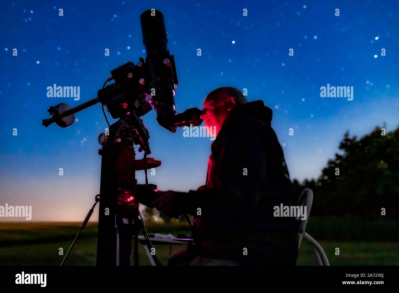 A selfie with me observing the North America Nebula in the fading moonlight (thus the blue sky) on August 8, 2019 from home, using the Astro-Physics T Stock Photo